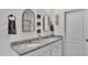 Bright bathroom features a double vanity with granite countertops and modern fixtures at 637 Griffon Ave, Lake Alfred, FL 33850