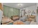 Bedroom featuring a crib, accent wall, and ample storage at 637 Griffon Ave, Lake Alfred, FL 33850