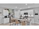 Bright kitchen features white cabinets, stainless steel appliances, and a granite island with bar seating at 637 Griffon Ave, Lake Alfred, FL 33850