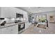 Modern kitchen boasts white cabinets, stainless steel appliances and granite countertops at 637 Griffon Ave, Lake Alfred, FL 33850