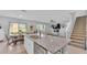 Open-concept kitchen with granite island, stainless steel dishwasher, adjacent to a dining area and living room at 637 Griffon Ave, Lake Alfred, FL 33850
