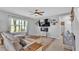 Cozy living room featuring a fireplace and large TV at 637 Griffon Ave, Lake Alfred, FL 33850