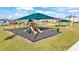Community playground with shaded play structures at 637 Griffon Ave, Lake Alfred, FL 33850
