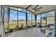 Relaxing screened porch with backyard view, wicker furniture, and ceiling fan at 637 Griffon Ave, Lake Alfred, FL 33850