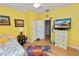 Bright bedroom with wood floors, a dresser, and a TV at 7246 Cedarcrest Blvd, Lakeland, FL 33810