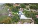 Bird's eye view of elegant homes with pools and docks on a scenic lakefront, nestled among verdant foliage at 739 Swann Dr, Lakeland, FL 33809