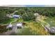Overhead view of waterfront homes with private docks on a picturesque lake surrounded by verdant trees at 739 Swann Dr, Lakeland, FL 33809