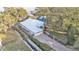 Sprawling single-story home featuring a metal roof, large lot, canal, and boat dock at 739 Swann Dr, Lakeland, FL 33809