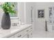 Bright bathroom features a double vanity, white cabinets, quartz counters, and modern fixtures at 739 Swann Dr, Lakeland, FL 33809
