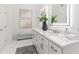Bright bathroom featuring double vanity, white cabinets, quartz counters, and modern fixtures at 739 Swann Dr, Lakeland, FL 33809