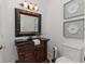 Powder room with framed vanity, dark countertop, framed art, and modern fixtures at 739 Swann Dr, Lakeland, FL 33809