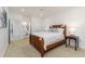 Bright bedroom with a wood bed frame, ensuite bathroom and plush carpet at 739 Swann Dr, Lakeland, FL 33809