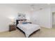 This bedroom features carpeted floors, a ceiling fan, and an ensuite bathroom at 739 Swann Dr, Lakeland, FL 33809