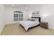This bedroom features carpeted floors, a ceiling fan, and an arched window with plantation shutters at 739 Swann Dr, Lakeland, FL 33809