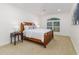 Charming bedroom features carpeted floors, a ceiling fan, and a bright arched window at 739 Swann Dr, Lakeland, FL 33809