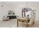 Bright dining area with a wooden table, seating for six, modern lighting, and elegant decor at 739 Swann Dr, Lakeland, FL 33809