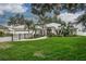 Beautiful single-story home featuring manicured lawn, gated driveway, and lovely tropical landscaping at 739 Swann Dr, Lakeland, FL 33809