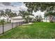 Beautiful single-story home featuring manicured lawn, gated driveway, and lovely tropical landscaping at 739 Swann Dr, Lakeland, FL 33809