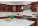 Stunning kitchen featuring cherry cabinets, stainless steel appliances, and a spacious island at 739 Swann Dr, Lakeland, FL 33809