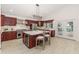 Bright kitchen featuring cherry cabinets, stainless steel appliances, a center island, and double doors to the backyard at 739 Swann Dr, Lakeland, FL 33809