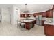 Well-appointed kitchen with cherry cabinets, stainless appliances, and an island, creating a stylish and functional space at 739 Swann Dr, Lakeland, FL 33809