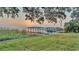 Lakeside dock view at sunrise framed by trees at 739 Swann Dr, Lakeland, FL 33809