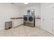 Laundry room features modern machines, tile floor, and ample counter space at 739 Swann Dr, Lakeland, FL 33809