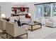 Open-concept living room featuring stylish furniture, a view into the kitchen, and access to the outdoor spaces at 739 Swann Dr, Lakeland, FL 33809