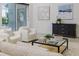 Tastefully decorated living room with elegant artwork, modern furniture, and sliding glass doors to the pool area at 739 Swann Dr, Lakeland, FL 33809
