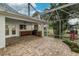 Screened patio featuring an outdoor kitchen with stainless steel appliances and brick pavers at 739 Swann Dr, Lakeland, FL 33809