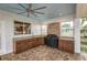 Covered outdoor kitchen, with stainless steel barbeque, granite counters and a tile floor at 739 Swann Dr, Lakeland, FL 33809