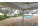 Screened pool and spa area with brick pavers, partial lake view and outdoor seating at 739 Swann Dr, Lakeland, FL 33809