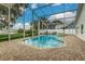 Screened-in pool and spa area with brick pavers, a view of the lake, and plenty of space for entertaining at 739 Swann Dr, Lakeland, FL 33809