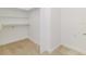 Walk-in closet features carpeted floors and ample shelving for storage and organization at 739 Swann Dr, Lakeland, FL 33809