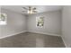 Spacious bedroom with ceiling fan and wood-look tile flooring at 815 N Hendry Ave, Fort Meade, FL 33841