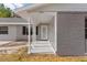 Covered porch with white columns and a light gray brick exterior at 815 N Hendry Ave, Fort Meade, FL 33841