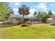 Back of house with screened porch and large yard at 815 N Hendry Ave, Fort Meade, FL 33841