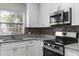 Modern kitchen with granite countertops and stainless steel appliances at 815 N Hendry Ave, Fort Meade, FL 33841