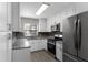 Modern kitchen featuring white cabinets, granite counters, and stainless steel appliances at 815 N Hendry Ave, Fort Meade, FL 33841