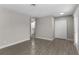 Living room with gray walls, wood-look tile floors, and access to other rooms at 815 N Hendry Ave, Fort Meade, FL 33841