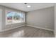 Living room with large window, gray walls, wood-look tile floors at 815 N Hendry Ave, Fort Meade, FL 33841
