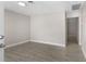 Bright and airy living room with gray walls, wood-look tile floors, and an open floor plan at 815 N Hendry Ave, Fort Meade, FL 33841
