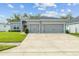 Two-story house with gray exterior and two-car garage at 8218 Wilder Loop, Lakeland, FL 33809