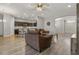 Open living room with brown couches and kitchen view at 8218 Wilder Loop, Lakeland, FL 33809