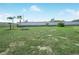 Spacious backyard with grassy lawn and partial privacy wall at 1007 Canary S Cir, Lakeland, FL 33809