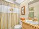 Bathroom with shower/tub combo and wood vanity at 1007 Canary S Cir, Lakeland, FL 33809