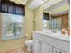 Clean bathroom with white vanity and tiled floor at 1007 Canary S Cir, Lakeland, FL 33809