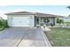 House exterior featuring a two-car garage and well-maintained landscaping at 1007 Canary S Cir, Lakeland, FL 33809