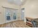 Living room with French doors leading to a sunroom and hardwood floors at 1007 Canary S Cir, Lakeland, FL 33809