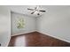 Bedroom with dark wood-style flooring and a window at 103 Clydebank Pl, Kissimmee, FL 34758